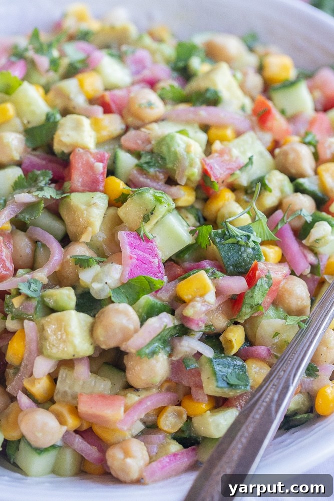 Tangy Avocado and Cucumber Salad with Pickled Onions 6 A close-up view of the summer corn salad with vibrant pickled onions, showcasing the fresh textures and inviting colors of the dish.