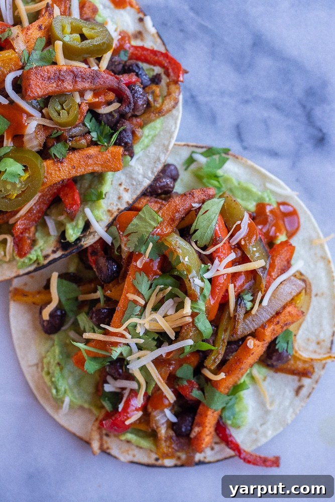 One-Pan Sweet Potato Black Bean Fajitas 5 Close-up of a single serving of sweet potato and black bean fajita on a cutting board, showcasing the rich colors and textures of the roasted vegetables.