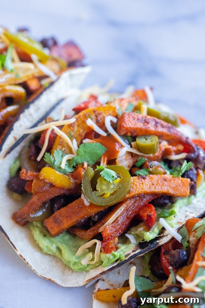 One-Pan Sweet Potato Black Bean Fajitas 6 Close-up of a sweet potato black bean fajita, garnished with fresh cilantro and vibrant slices of jalapeño for an extra kick.