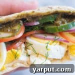 Close up of a vegetarian breakfast pita with fresh herbs