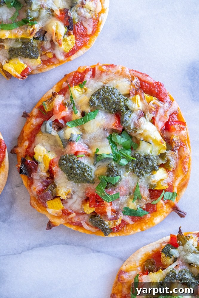 Affordable Plant-Based Meal Plan Week 22 7 Roasted Vegetable Tortilla Pizzas on a baking sheet