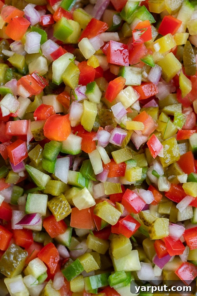 Close-up view of finely chopped Pickle De Gallo in a bowl, showcasing its fresh and vibrant ingredients.
