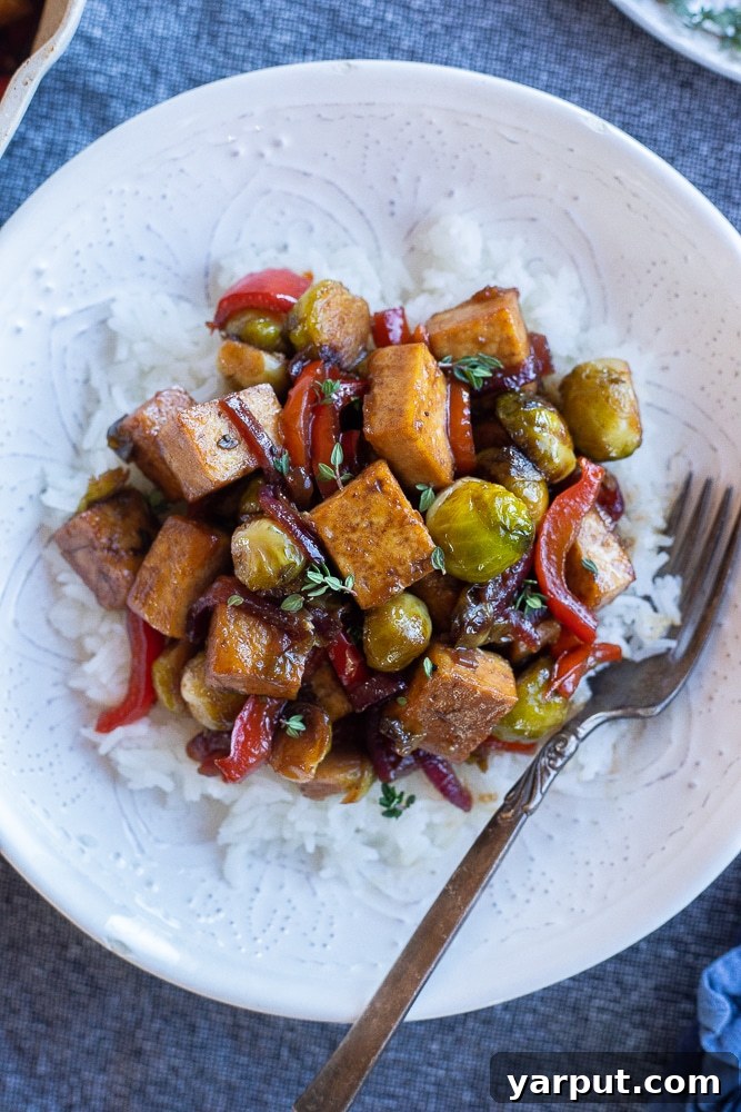 A colorful stir-fry of balsamic glazed tofu and mixed vegetables served in a bowl.