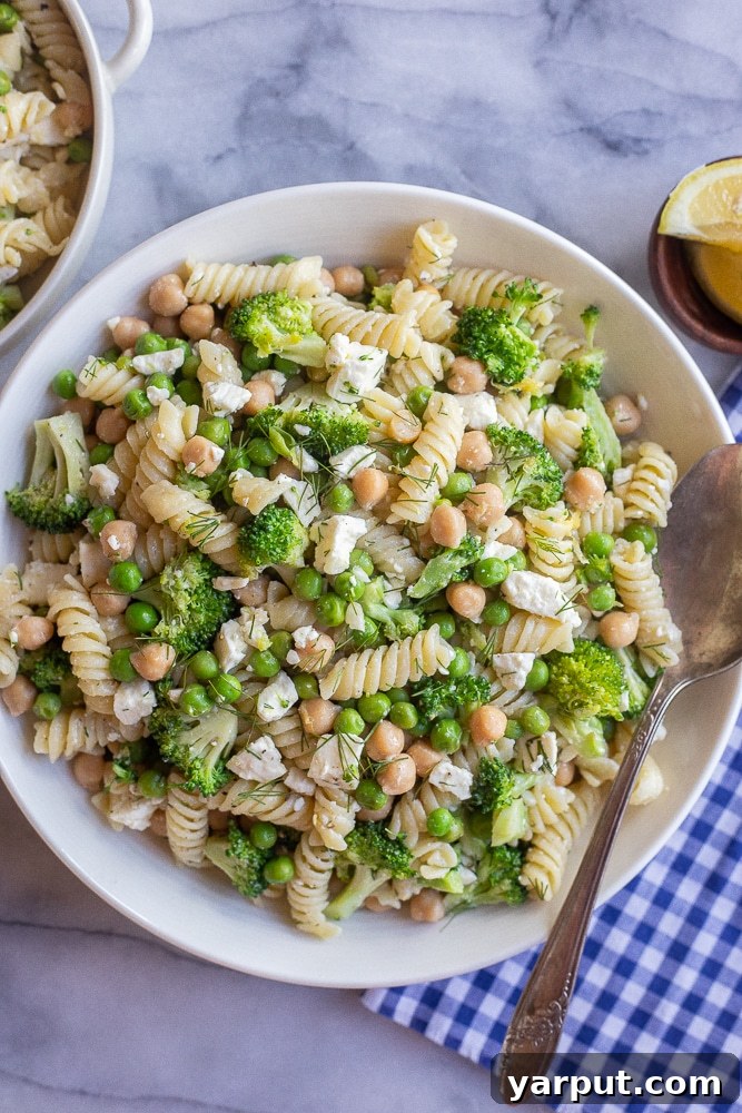 Zesty Lemon Broccoli Feta Pasta Salad 5 Lemon Broccoli Pasta Salad in a serving bowl with a spoon and napkin