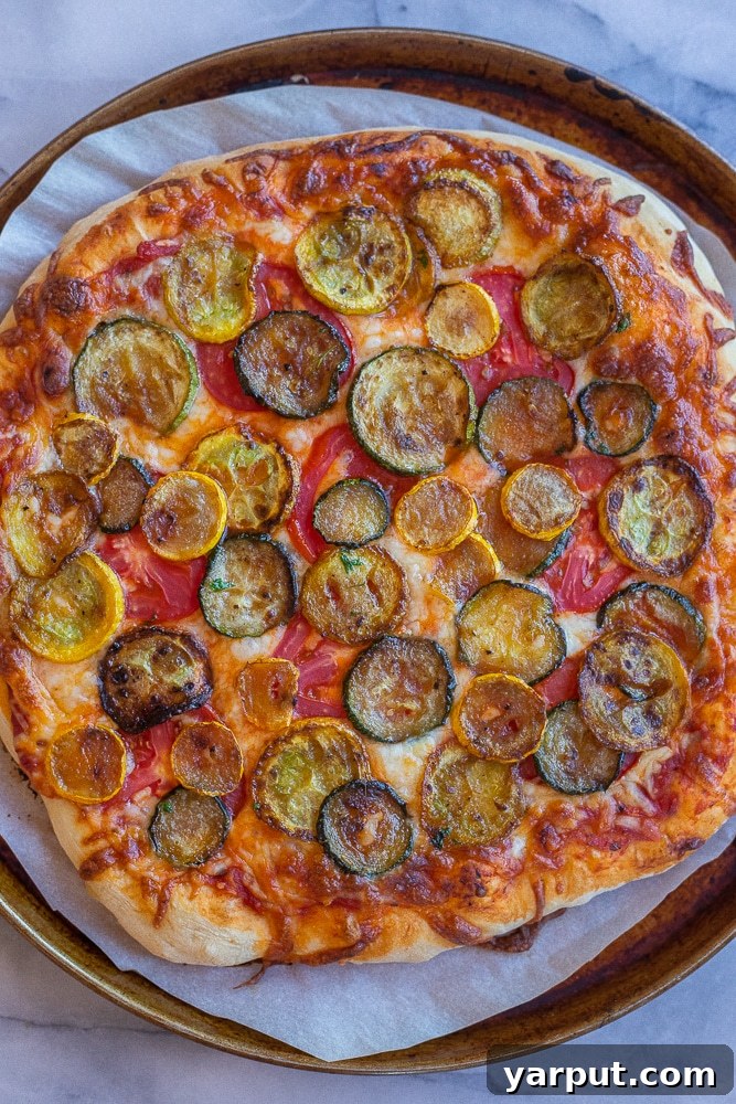 Vibrant Summer Squash and Tomato Pizza 4 A freshly baked Summer Squash and Tomato Pizza, garnished with fresh green herbs, resting on a cooling rack just out of the oven. The cheese is perfectly melted, and the crust is golden brown.