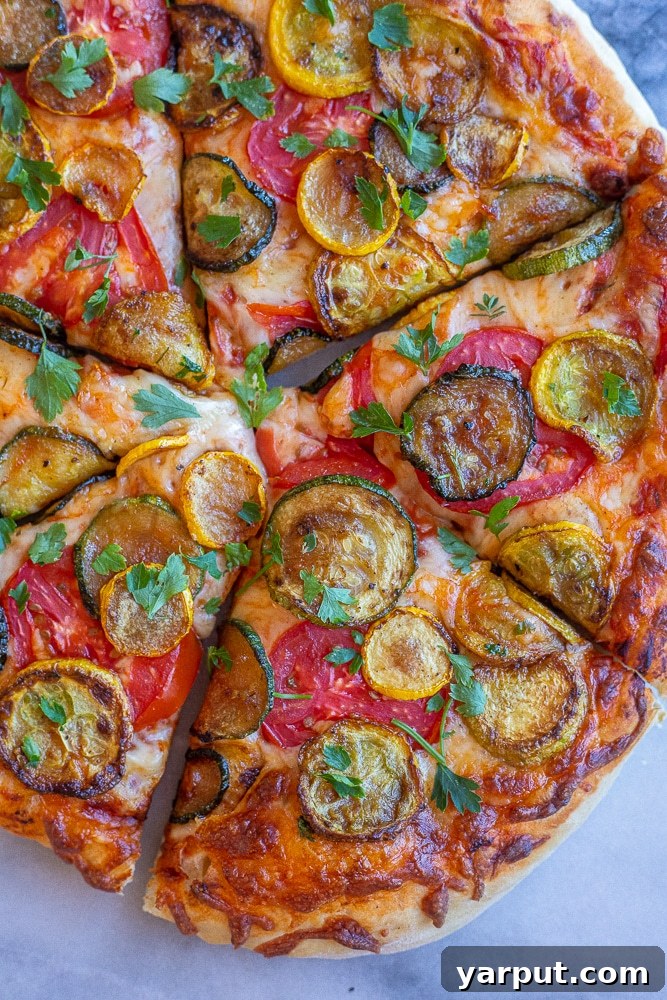 Vibrant Summer Squash and Tomato Pizza 5 A close-up shot of a single slice of Summer Squash and Tomato Pizza, showing the delicious layering of caramelized squash, melted mozzarella, and fresh red tomatoes on a crispy crust, garnished with herbs.