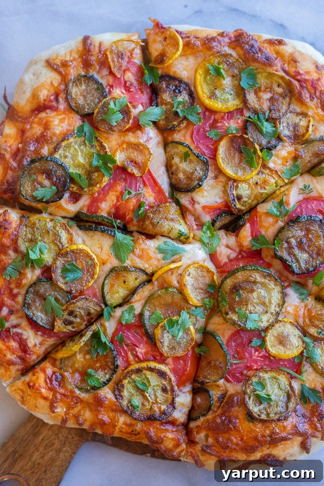 Week 25: Budget-Smart Vegetarian Meal Plan 7 A homemade pizza topped with colorful summer squash and tomatoes, ready for a delicious Friday dinner.