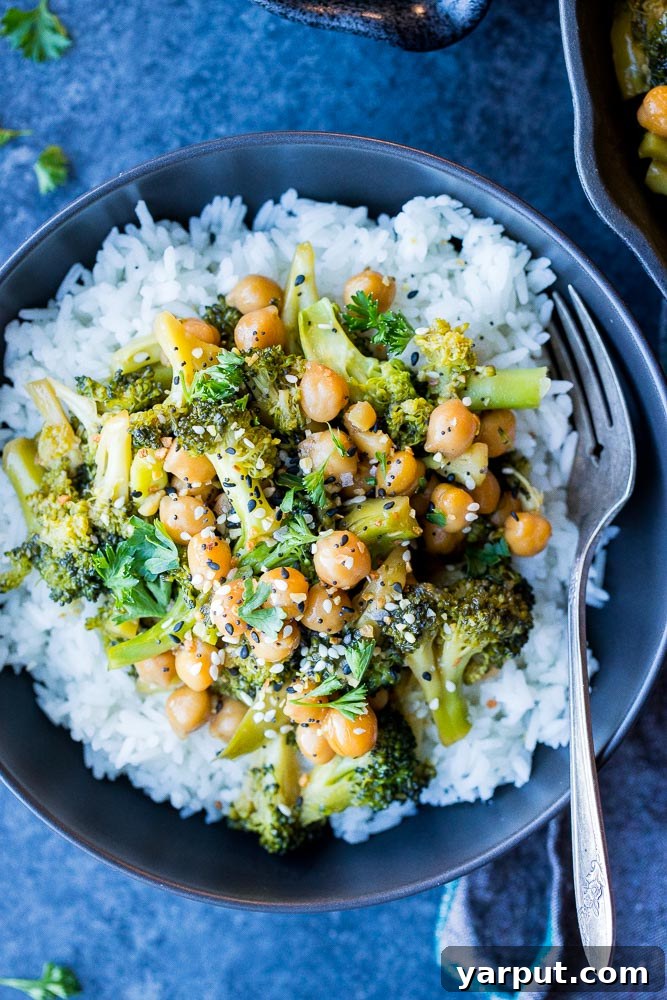 Veggie on a Budget: Meal Plan Week 26 6 A vibrant teriyaki stir fry with tender broccoli florets and chickpeas, coated in a glossy sauce, served in a pan.