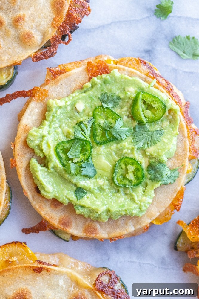 Golden Zucchini and Sweet Corn Quesadillas 6 A vibrant corn and zucchini quesadilla generously topped with homemade guacamole, fresh jalapeños, and cilantro sprigs.