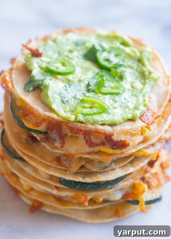 Golden Zucchini and Sweet Corn Quesadillas 7 A stack of five golden brown corn and zucchini quesadillas, revealing layers of melted cheese and vibrant vegetable filling, looking irresistible.