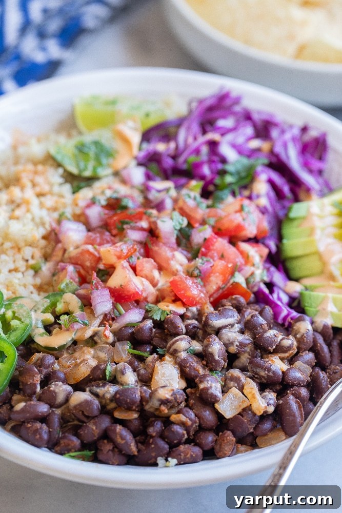 Fiesta Black Bean Quinoa Bowls with Chipotle Tahini Drizzle 6 close up of seasoned black beans in the quinoa bowls