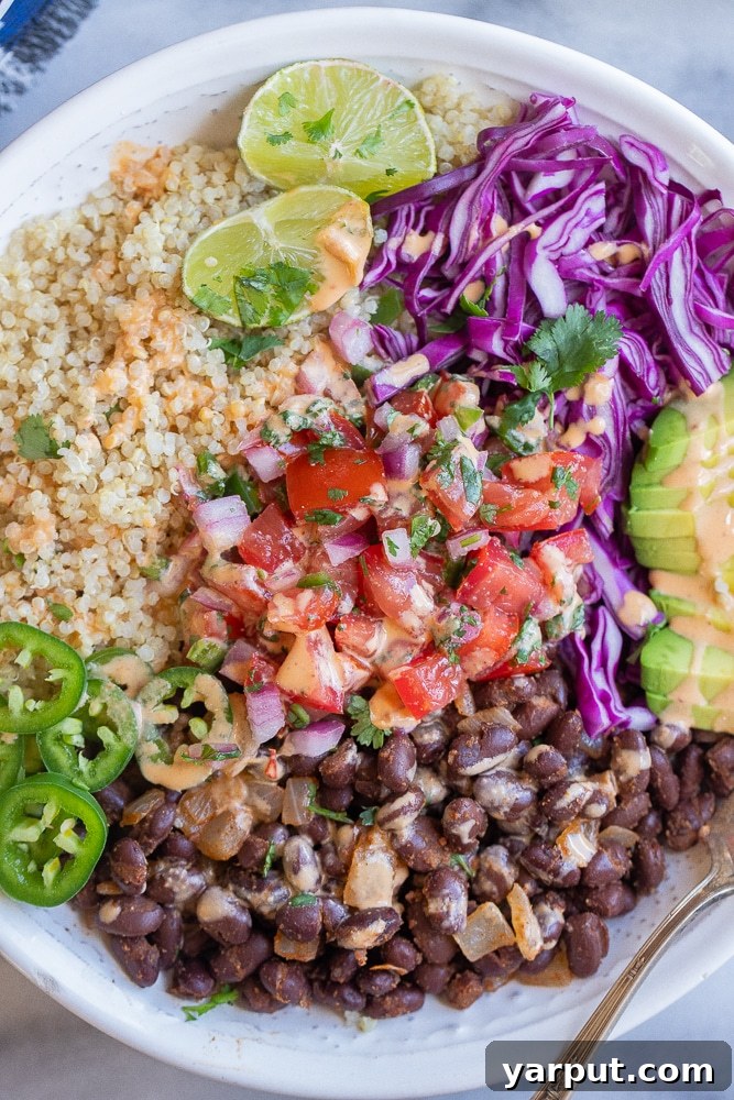 Fiesta Black Bean Quinoa Bowls with Chipotle Tahini Drizzle 7 close up of a black bean quinoa bowl with lots of toppings