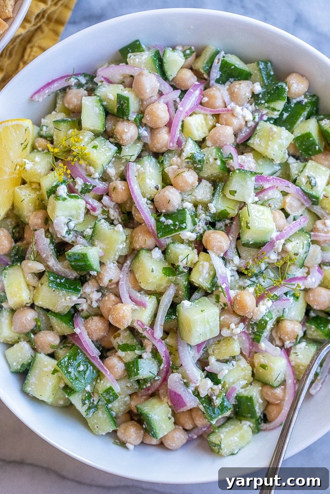 Close up of lemon feta cucumber salad in a serving bowl, showcasing its vibrant ingredients