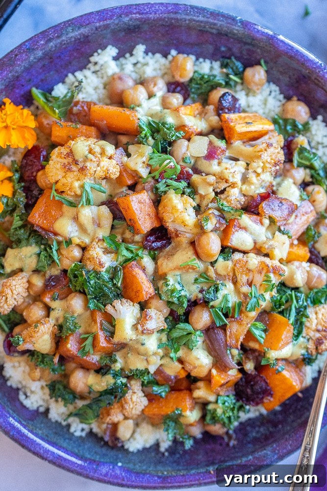 Golden Roasted Cauliflower & Sweet Potato Bowls with Creamy Curry Tahini 2 close up of roasted cauliflower and sweet potato bowls with kale and curry tahini dressing