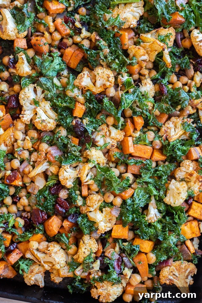 Golden Roasted Cauliflower & Sweet Potato Bowls with Creamy Curry Tahini 5 close up of the roasted veggies on a sheet pan