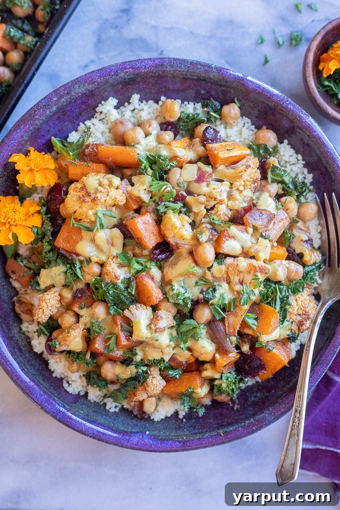 Golden Roasted Cauliflower & Sweet Potato Bowls with Creamy Curry Tahini 6 purple bowl filled with couscous and roasted veggies topped with tahini dressing