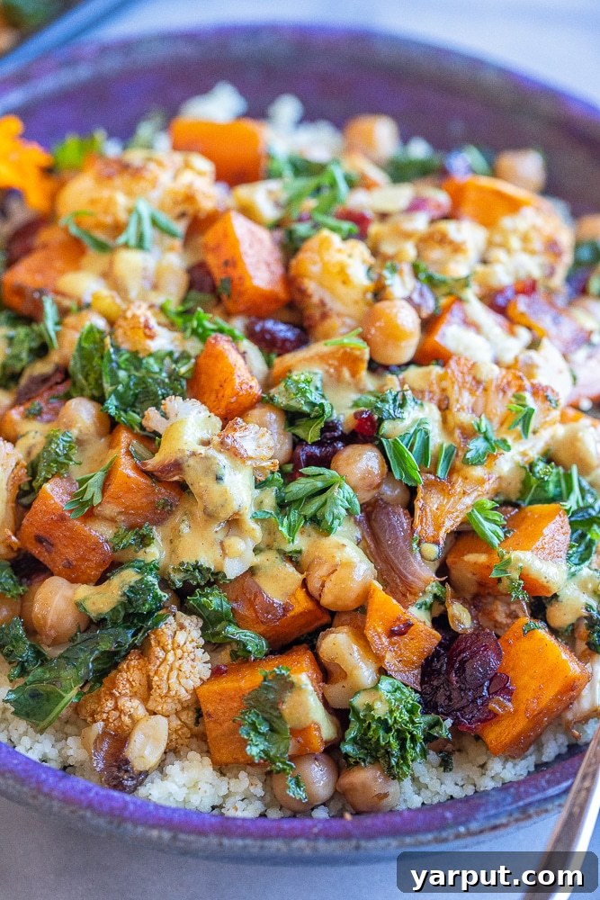 Golden Roasted Cauliflower & Sweet Potato Bowls with Creamy Curry Tahini 7 close up of a nourishing buddha bowl with roasted veggies