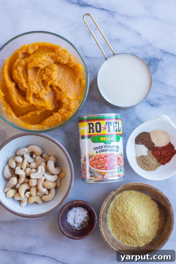 Creamy Plant Based Pumpkin Queso 3 all the fresh ingredients laid out on a wooden board, ready to make the vegan pumpkin queso dip