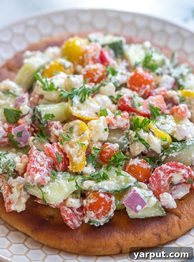 Loaded Pita Pockets with Creamy Feta and Fresh Vegetables 6 a beautifully plated greek salad pita on a white plate
