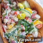 Close-up of a creamy feta and veggie pita, showing the delicious filling
