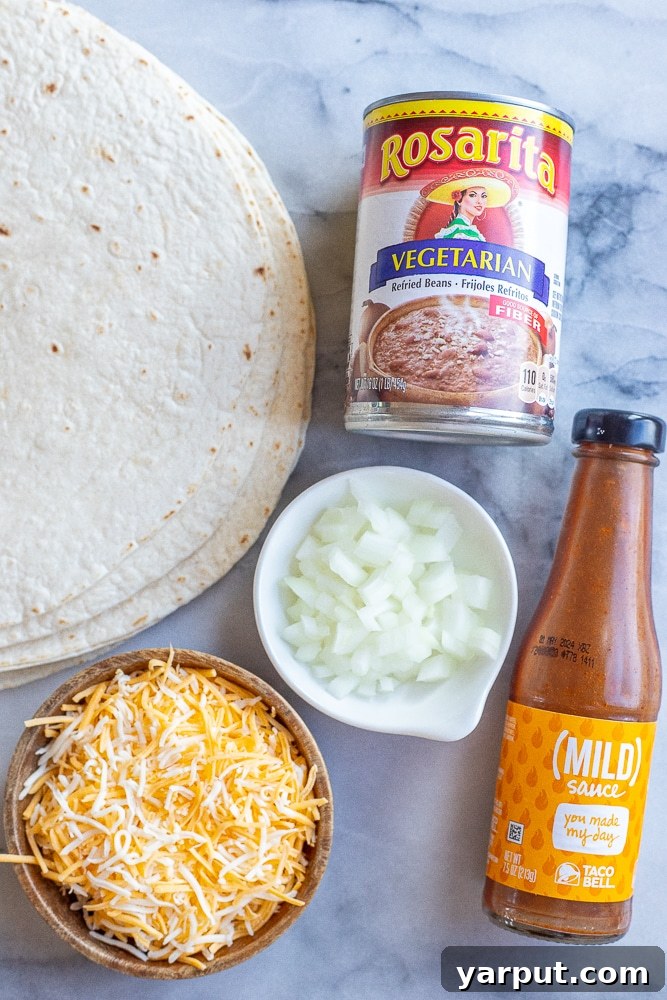 Homemade Taco Bell Bean Burrito Perfection 3 All essential ingredients for making Taco Bell copycat bean burritos laid out on a clean surface