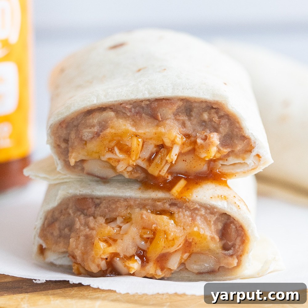 Homemade Taco Bell Bean Burrito Perfection 7 Close up shot of the inside of a warm bean and cheese burrito, showing layers of filling
