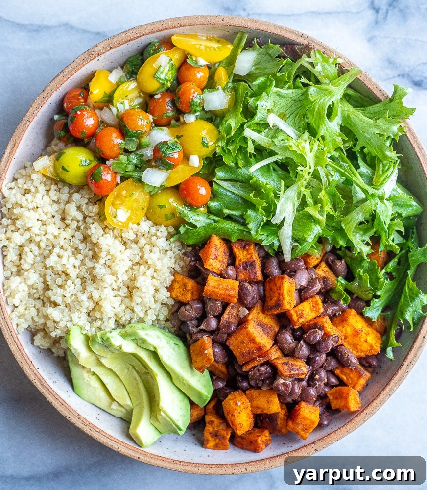 Vibrant Sweet Potato Quinoa Bowls with Green Chile Tahini 5 A beautifully assembled Sweet Potato Quinoa Bowl with black beans, fresh pico de gallo, crisp lettuce, and creamy avocado, ready to be enjoyed.