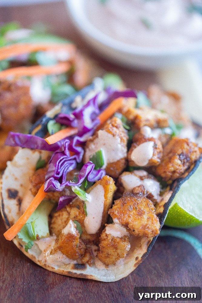 close up of a tofu fish taco with crispy veggies