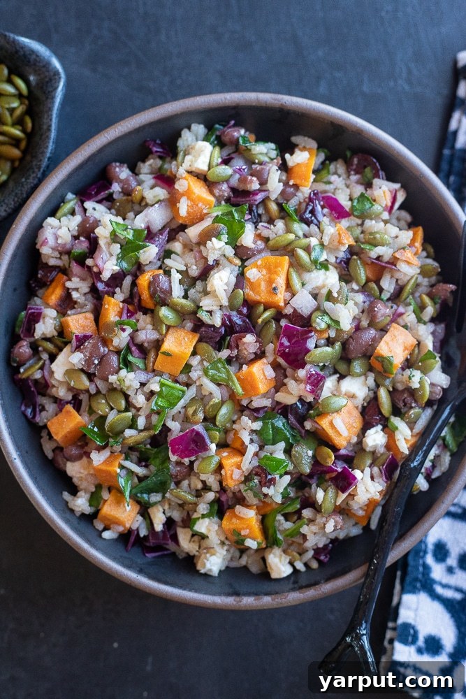 Spooky Rice and Veggie Medley 7 Halloween Salad with Rice and Veggies in a black bowl on a black table with festive decorations