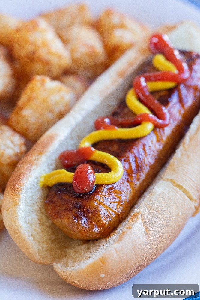 Whip Up Your Own Vegan Hot Dogs 2 close up of a vegan hot dog in a bun topped with ketchup and mustard