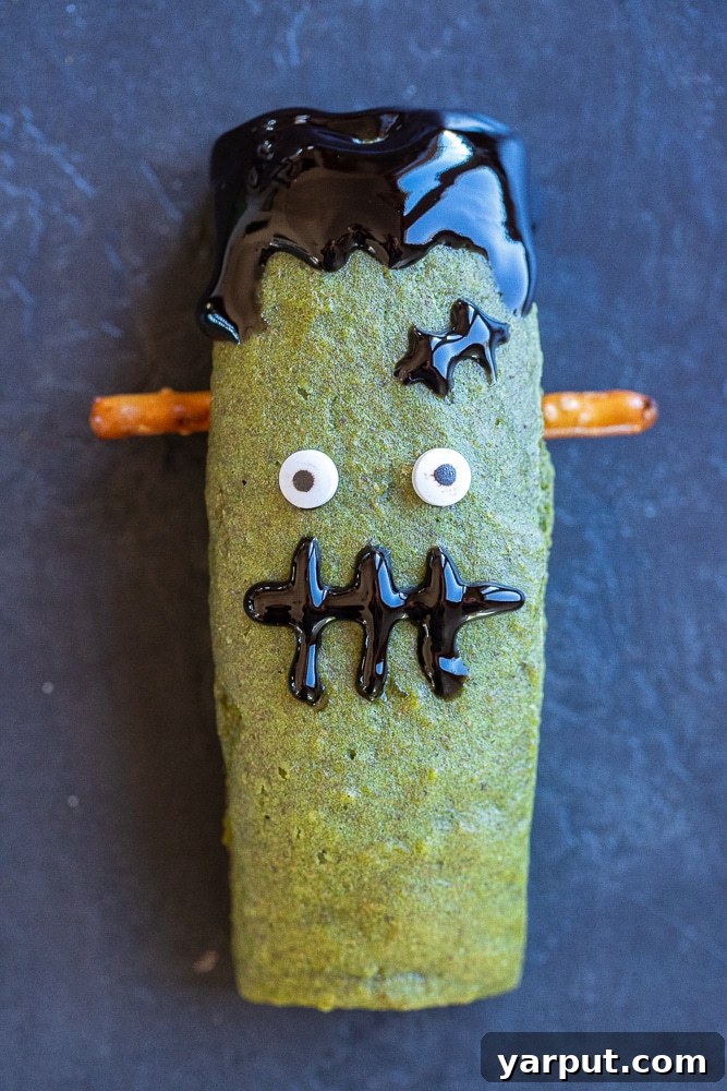 Spooky Smart Frankenstein Treats 7 Close-up shot of a healthy, kid-friendly Halloween treat shaped like Frankenstein, showcasing detailed decorations and vibrant green color.