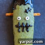 Healthy Frankenstein Halloween Bars with candy eyes and pretzel bolts.