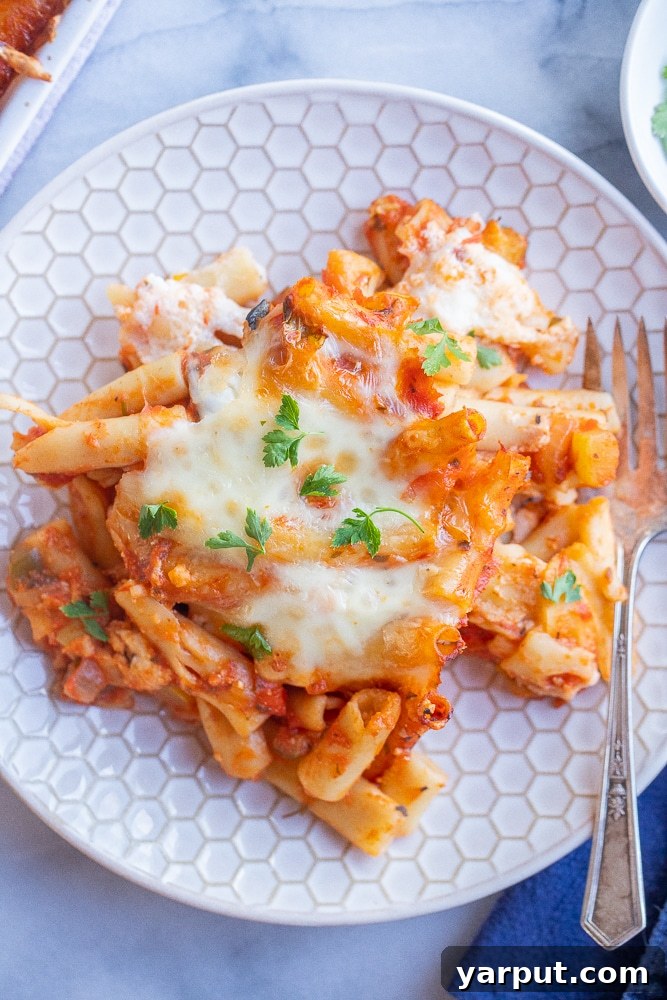 Vibrant Veggie Wellness Week 36 3 A delicious pan of vegetarian baked ziti pasta, bubbling with melted cheese and rich tomato sauce, garnished with fresh herbs, perfect for a family dinner.