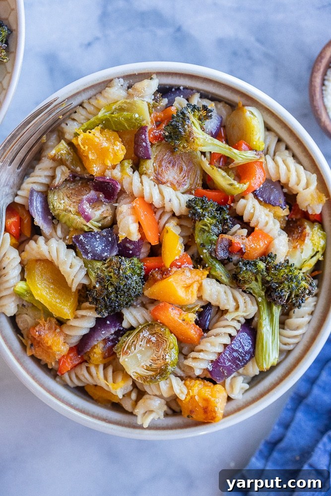 Wholesome Plant-Based Eats for Week 38 4 A generous serving of Easy Roasted Vegetable Pasta with Parmesan, featuring colorful roasted vegetables and freshly grated cheese.