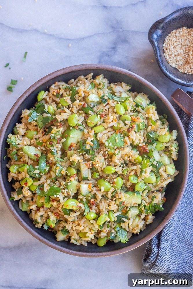 Refreshing Cucumber Edamame Rice Salad 6 a black ceramic bowl full of Asian inspired rice salad