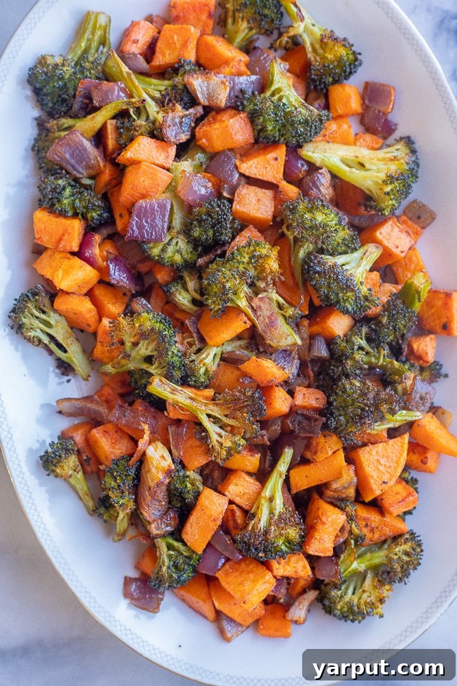 Curry Tahini Drizzled Roasted Sweet Potato and Broccoli 5 Roasted sweet potato and broccoli arranged neatly on a festive serving platter, glistening with curry tahini sauce and vibrant toppings.