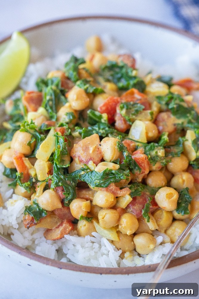 close up of a bowl of hearty chickpea curry with kale