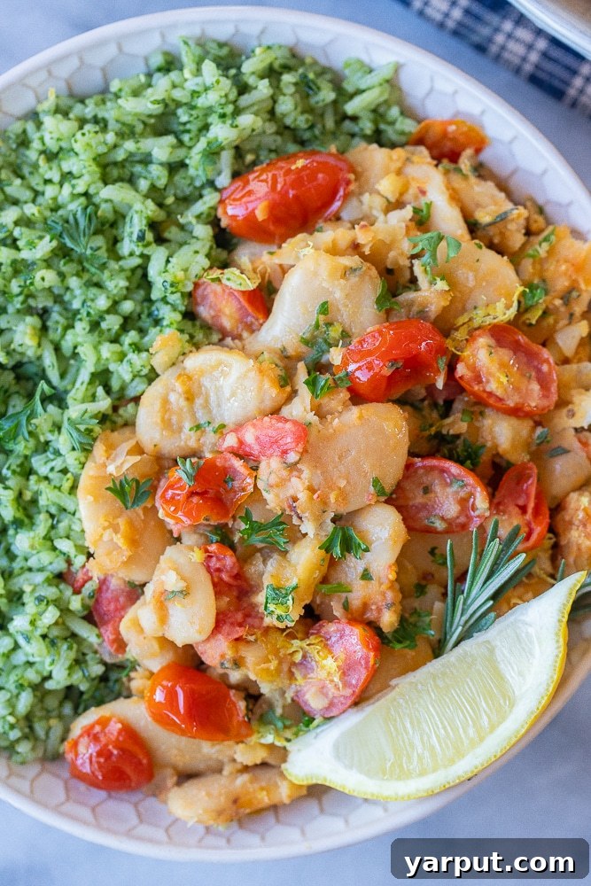 Easy Vegetarian Meal Plan: Week 41 3 A bowl of vibrant tomato herb butter beans served with a side of green pesto rice, a perfect quick and budget-friendly vegetarian meal.