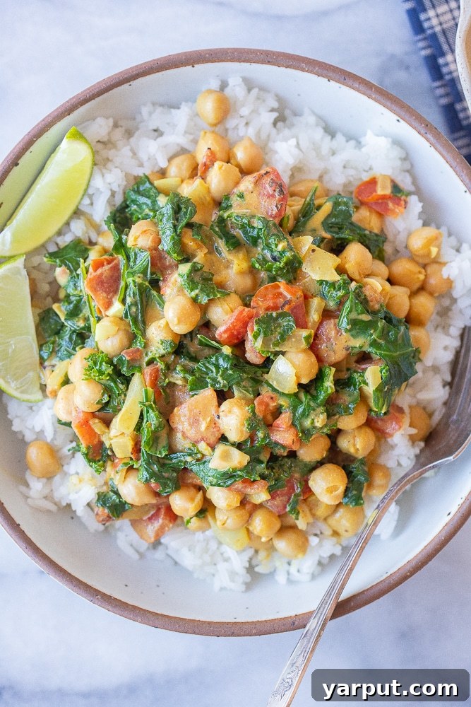Easy Vegetarian Meal Plan: Week 41 6 A bowl of quick and easy chickpea curry with vibrant kale, served over fluffy rice, a healthy and protein-rich vegetarian meal.