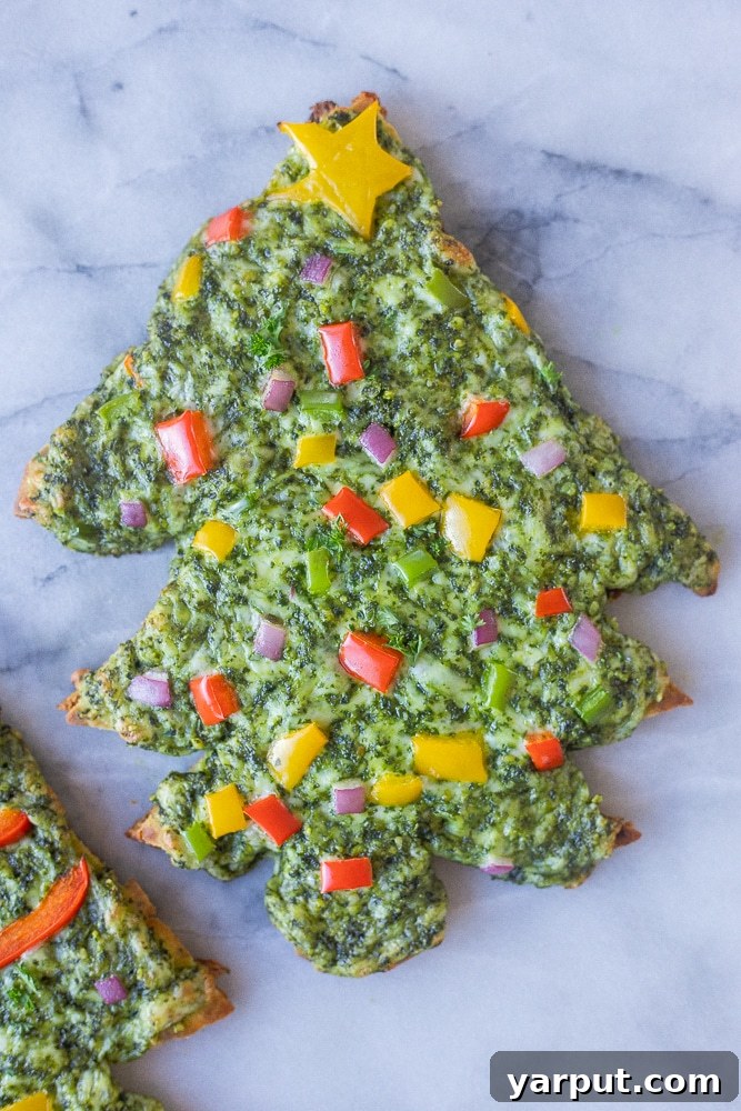 Easy Vegetarian Meal Plan: Week 41 7 Festive cheesy Christmas tree shaped naan pesto pizzas, perfect for a fun, easy, and family-friendly vegetarian Friday night meal.