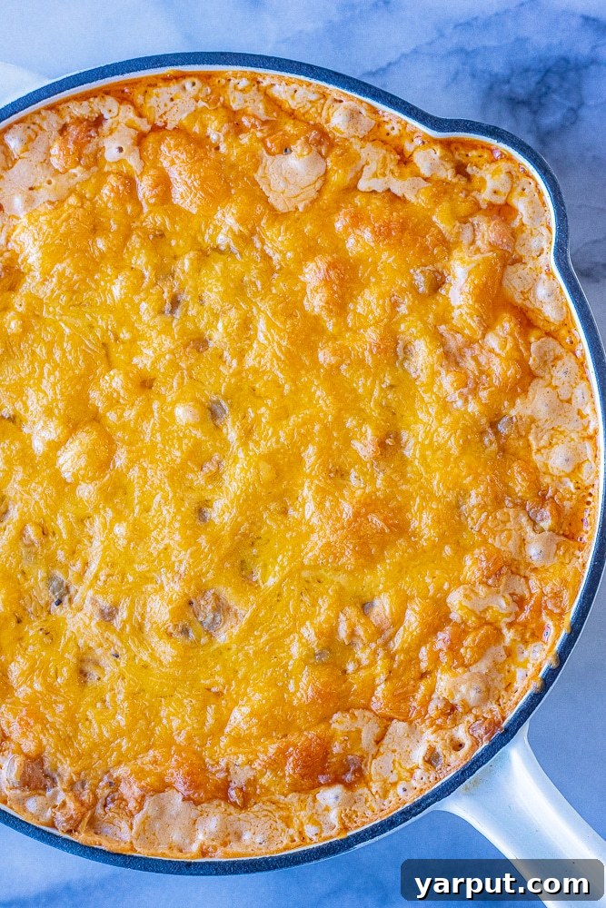 Ultimate Plant-Based Buffalo Chickpea Dip 5 A close-up view of a bubbling, cheesy vegetarian buffalo chickpea dip straight from the oven, showing its perfect gooey texture.