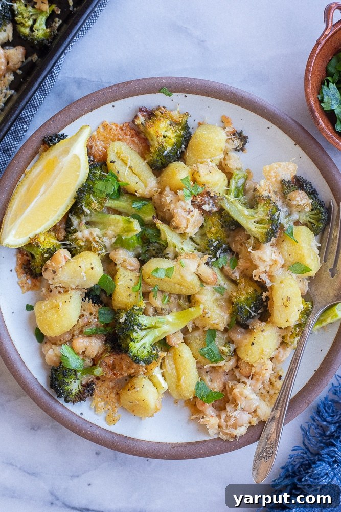 Effortless Vegetarian Eating: Week 2 3 Sheet pan dinner with golden-brown Parmesan crusted gnocchi, bright green broccoli florets, and creamy white beans, ready to serve.