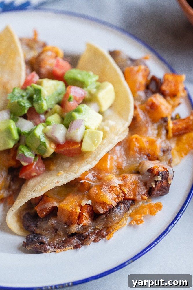 Effortless Vegetarian Eating: Week 2 7 Delicious roasted sweet potato and black bean tacos with melty cheese and guacamole.