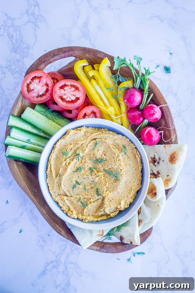 Golden Carrot Dill Hummus 5 A generous serving of healthy Roasted Carrot and Dill Hummus, ideal for a snack or party appetizer.