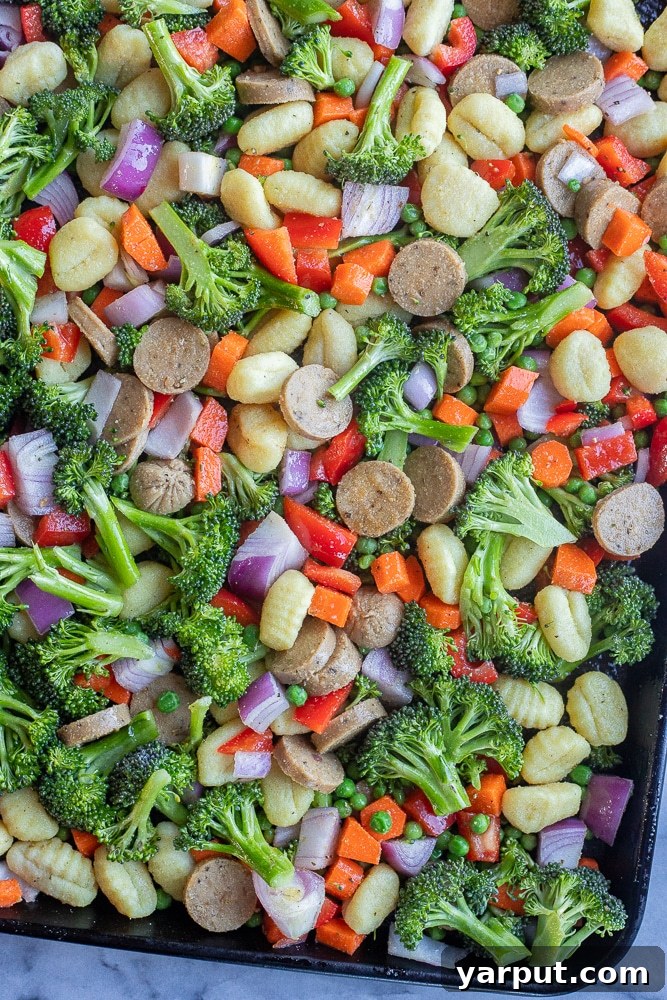 Rustic Sausage, Gnocchi, and Roasted Vegetable Casserole 3 Vegetarian sheet pan dinner with gnocchi, plant-based sausage, and a vibrant assortment of roasted vegetables on a baking tray.