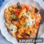 close-up of vegetarian cheesy tortellini casserole with a spoon