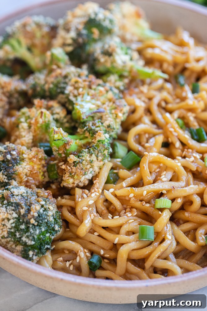 Sticky Teriyaki Noodles with Crispy Roasted Broccoli 6 A tempting close-up view of richly coated teriyaki noodles, showcasing their glossy sauce and tender texture, with the promise of crispy broccoli nearby.