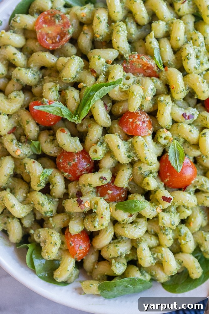 Pasta with Creamy Vegan Avocado Pesto 2 Close up of vegan avocado pesto pasta with cherry tomatoes and fresh basil
