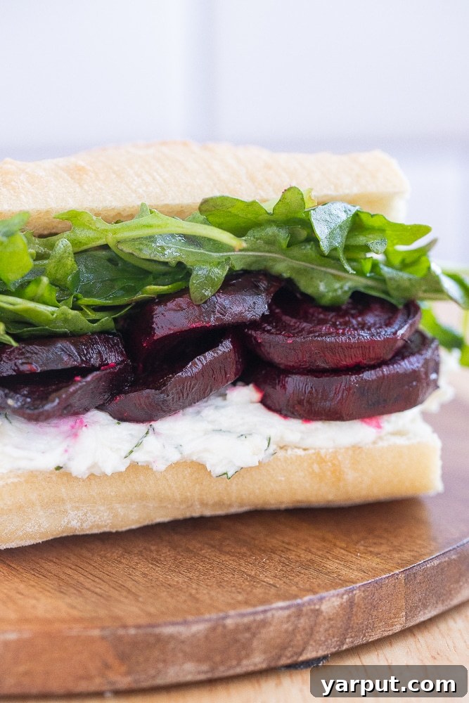 A cluster of fresh, vibrant red beets with their green leaves attached, resting on a rustic wooden surface, highlighting their earthy beauty.