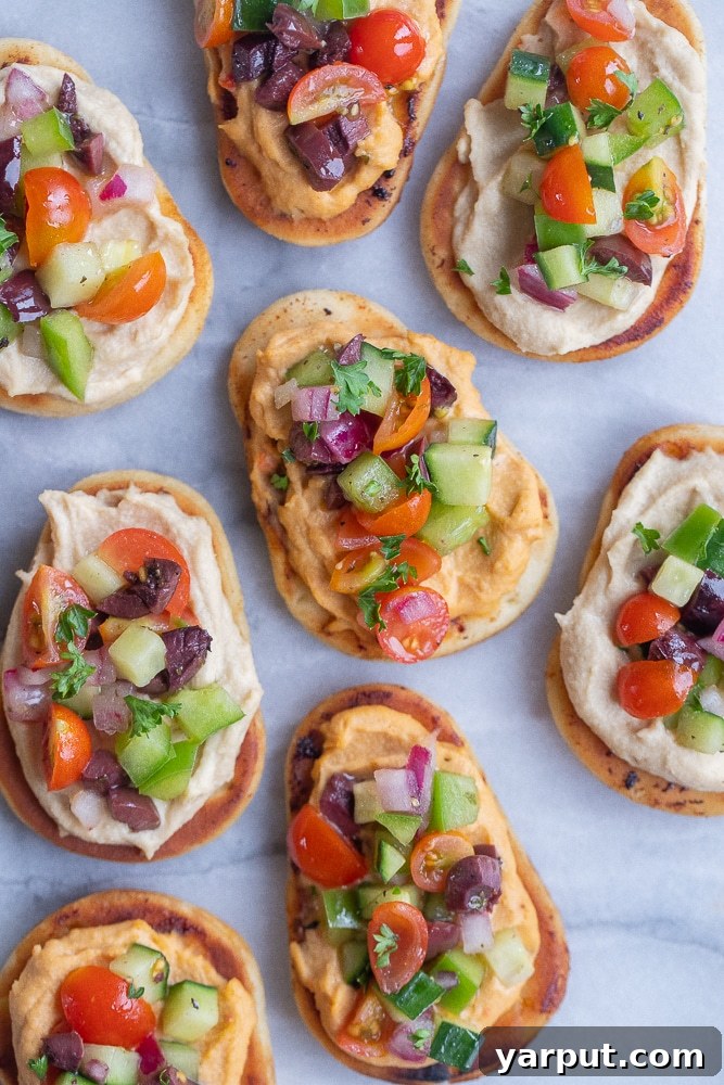 Zesty Greek Naan Nibblers with Hummus 2 A beautifully styled plate of Greek Salad Naan Bites, ready to be served at a gathering or enjoyed as a healthy snack.